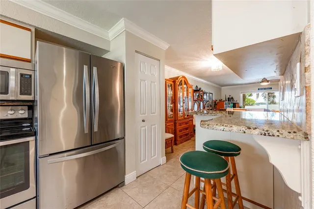 a dining room with furniture and a large window