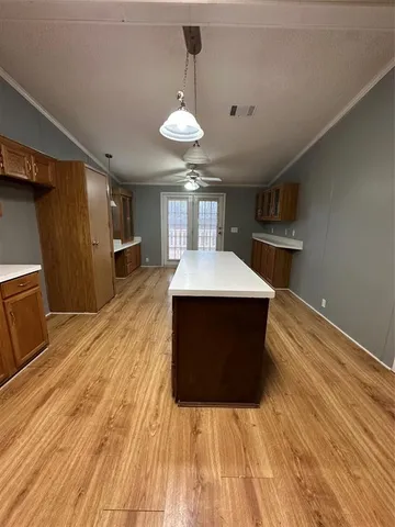 a large room with wooden floor and chandelier
