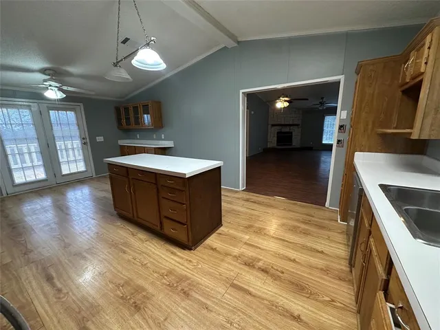 a kitchen with stainless steel appliances granite countertop a sink and a stove