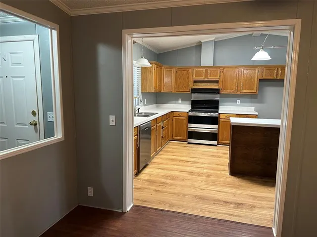 a kitchen with stainless steel appliances granite countertop a stove and a refrigerator