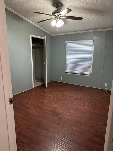 a view of a livingroom with a ceiling fan and window