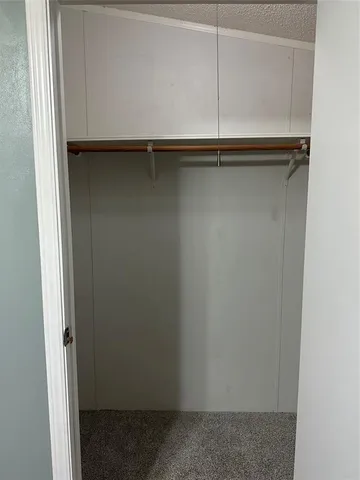 a view of a refrigerator in kitchen and livingroom