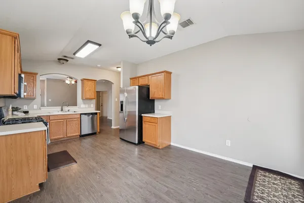 a kitchen with a refrigerator and a stove top oven