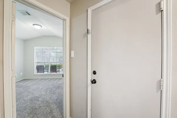 a view of an empty room with windows