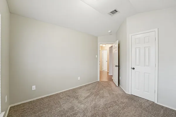 a view of an empty room and closet area