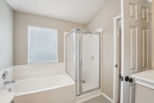 a bathroom with a bathtub and a shower
