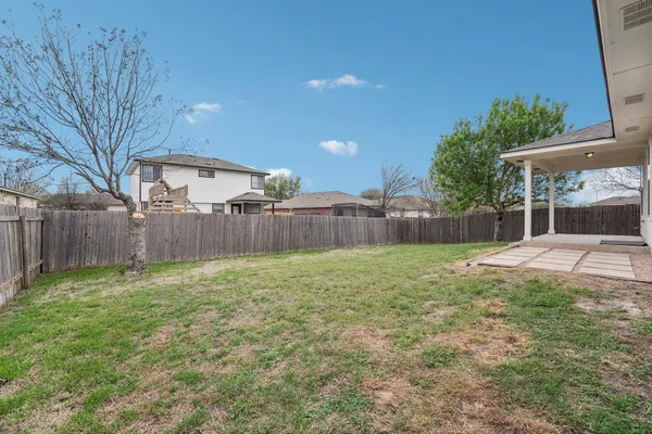 a view of a backyard with a garden and trees