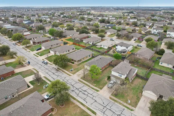 an aerial view of residential houses with outdoor space