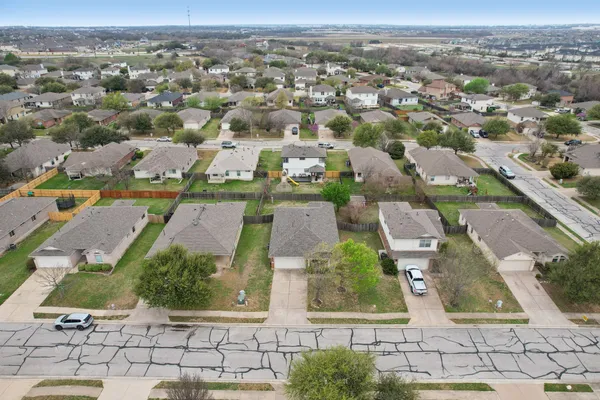 an aerial view of residential houses with outdoor space