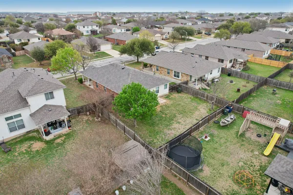 an aerial view of residential houses with outdoor space