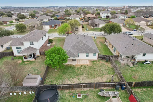 an aerial view of residential houses with outdoor space and swimming pool