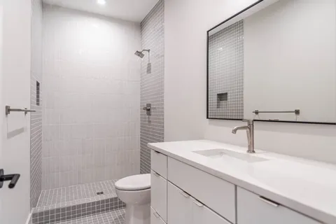 a bathroom with a sink toilet and shower