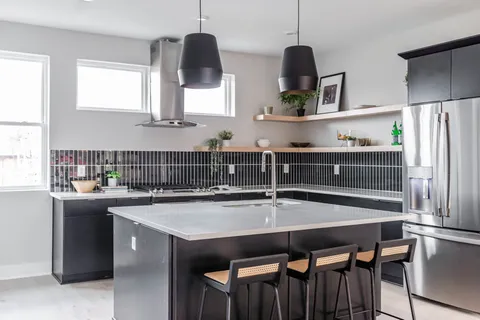 a kitchen with stainless steel appliances a sink a stove and a wooden floors