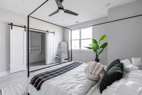 a bedroom with a bed and a chandelier