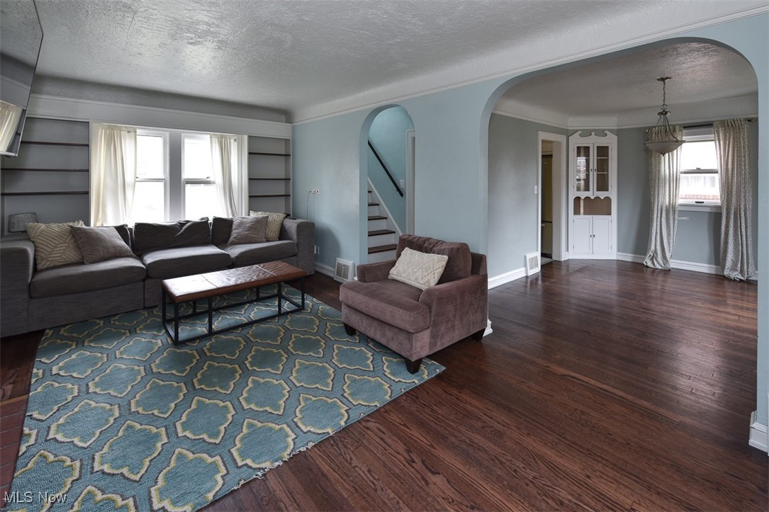 999 Pennfield Road Cleveland, OH 44121 - Photo 4 of 42 Living room featuring dark wood-type flooring, built in features