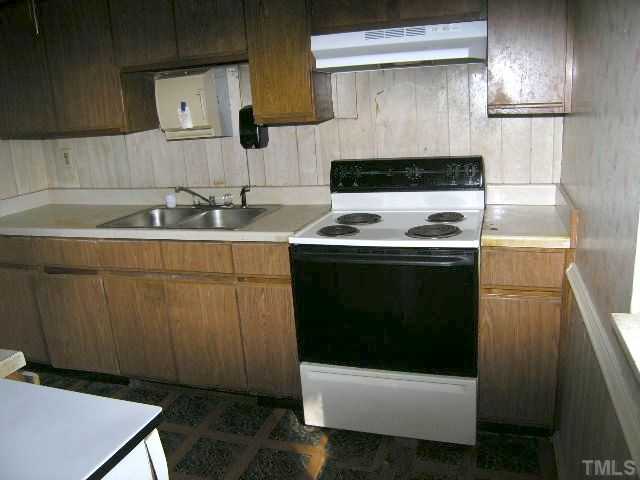 1913 Crawford Road Raleigh, NC 27610 - Photo 7 of 12 a kitchen with a sink a stove and refrigerator