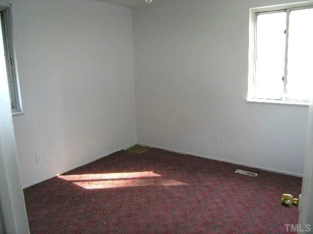 1913 Crawford Road Raleigh, NC 27610 - Photo 8 of 12 an empty room with a window