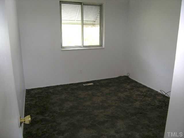 1913 Crawford Road Raleigh, NC 27610 - Photo 9 of 12 an empty room with a window