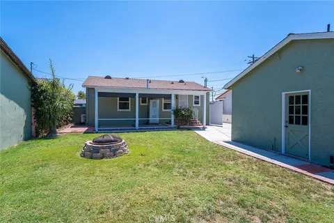 a front view of house with yard and outdoor seating