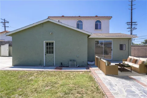 a backyard of a house with table and chairs