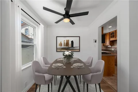 a view of a dining room with furniture window and wooden floor