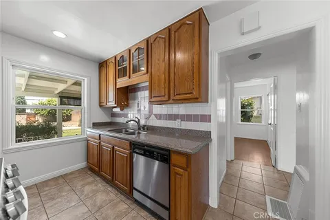 a kitchen with stainless steel appliances granite countertop a sink and cabinets