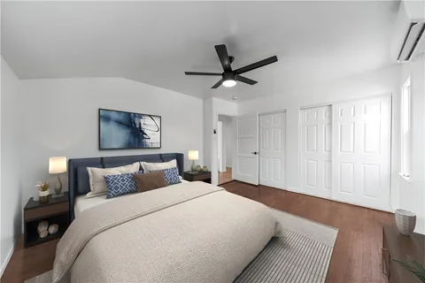 a bedroom with a large bed and a chandelier