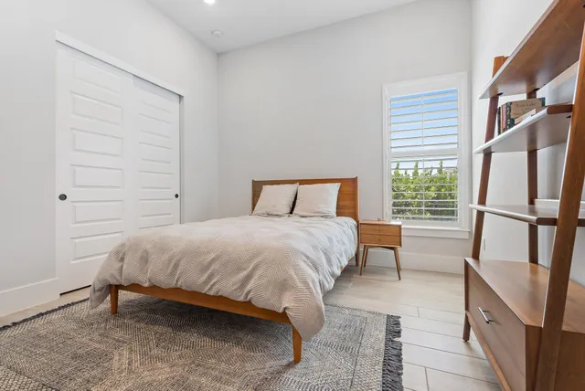 a living room with furniture kitchen view and a wooden floor