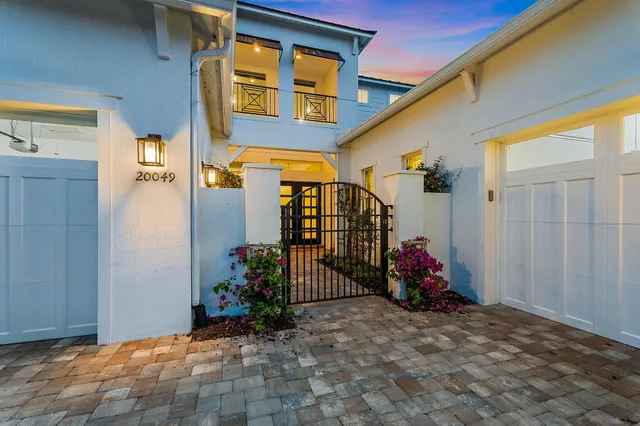 a kitchen with stainless steel appliances a stove a sink a oven a counter space and living room view