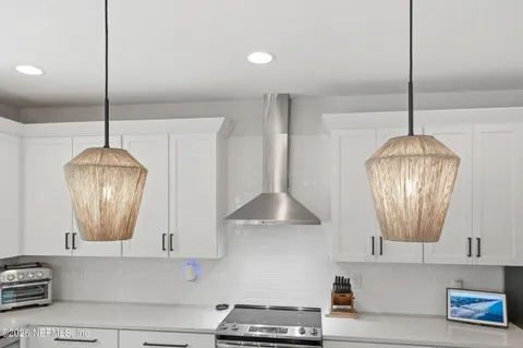 a kitchen with a chandelier a stove and a chandelier