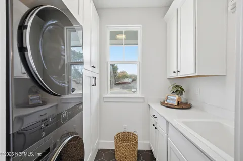 a kitchen with a sink a window and stainless steel appliances