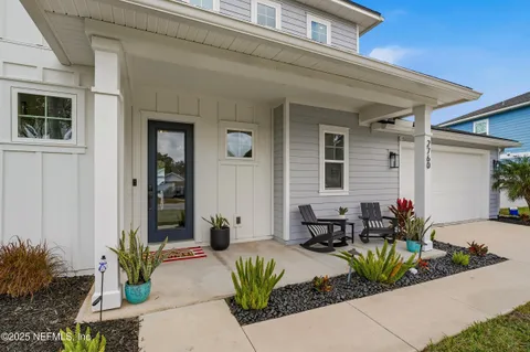 a front view of a house with outdoor seating
