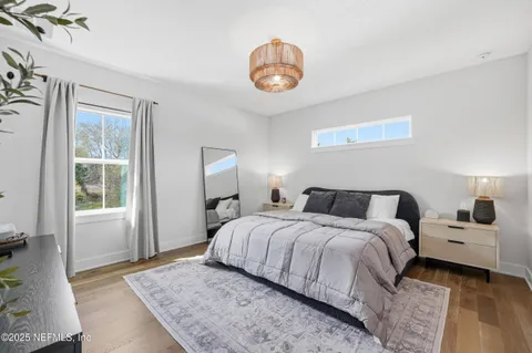 a bedroom with a bed and a chandelier