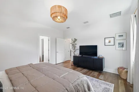 a bedroom with a bed and a television