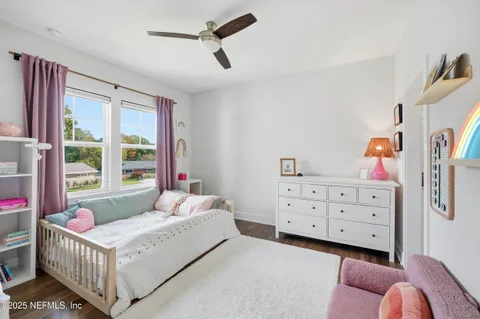a view of a patio with table and chairs potted plants with wooden floor and fence