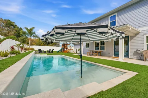 a view of a backyard with sitting area