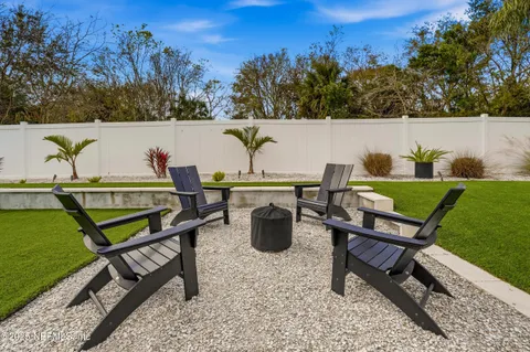 a view of a house with backyard water and sitting area