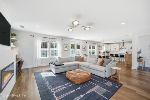 a living room with furniture a flat screen tv and a fireplace