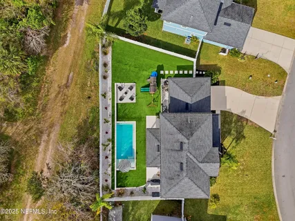 an aerial view of residential houses with outdoor space