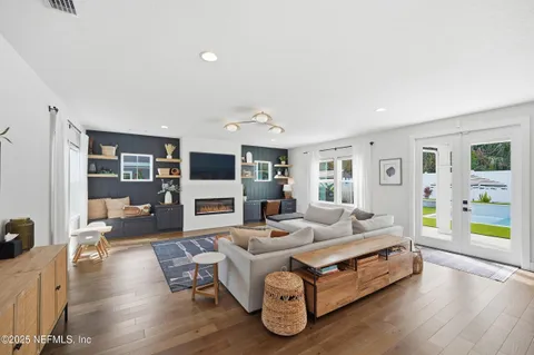 a living room with furniture and wooden floor