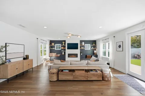 a living room with furniture and wooden floor