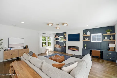 a living room with furniture flat screen tv and a fireplace