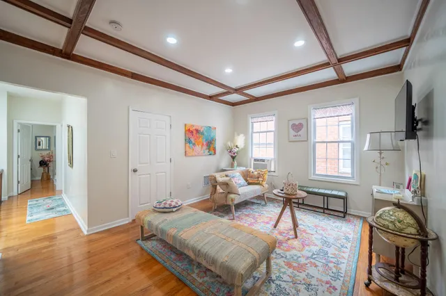 a living room with furniture and a wooden floor