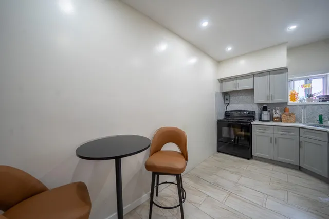 a kitchen with stainless steel appliances granite countertop a stove a sink dishwasher and a microwave with wooden floor