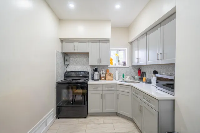 a kitchen with a stove top oven sink and cabinets