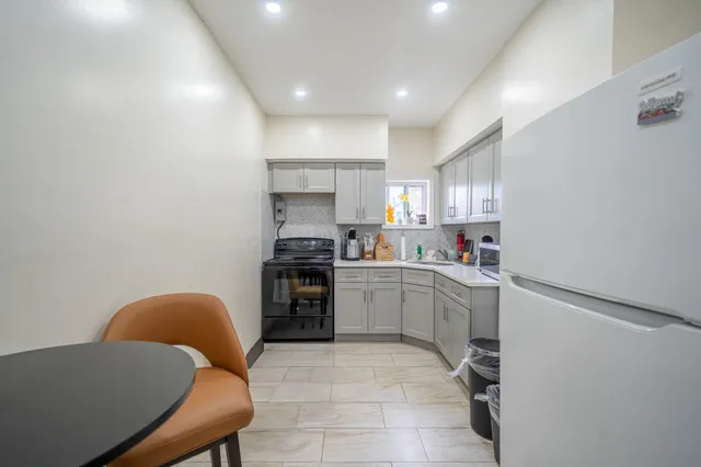 a kitchen with a sink cabinets and window