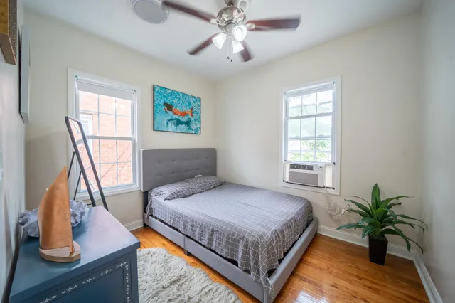 a bedroom with a large bed and a chandelier