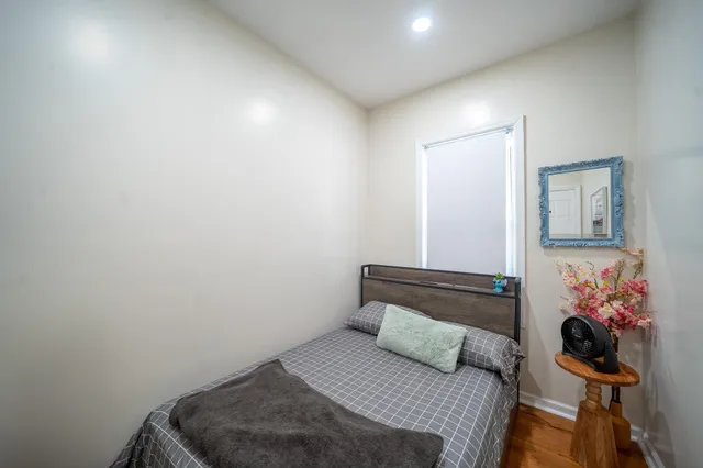 a bedroom with a bed and a potted plant