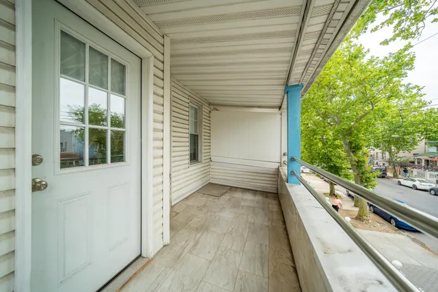 a view of a balcony with wooden floor