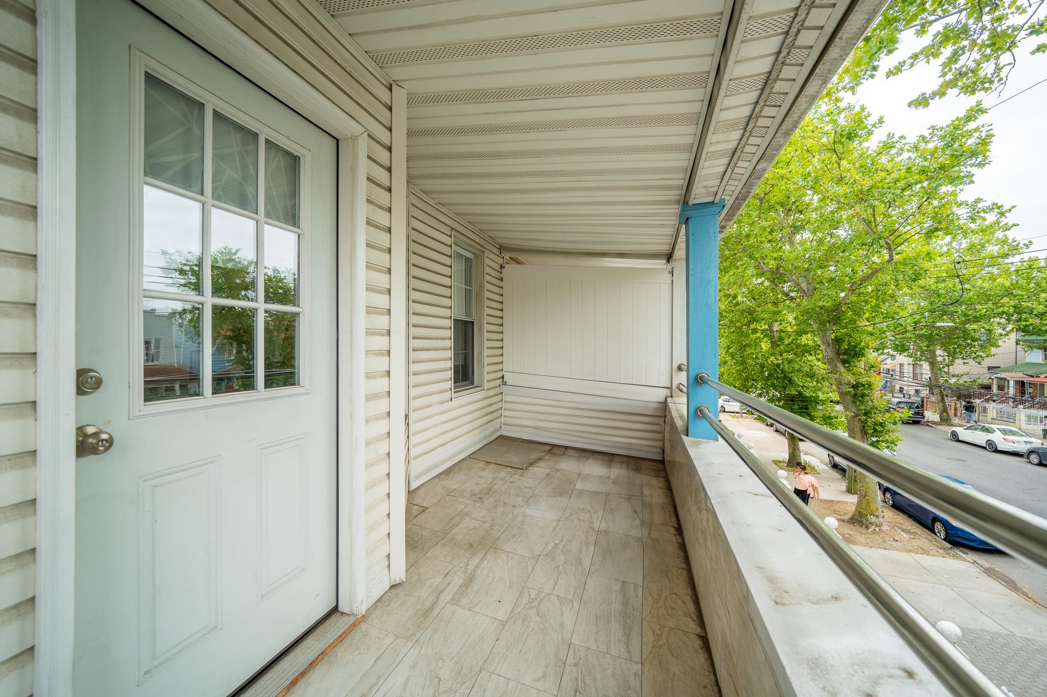 104-21 Lefferts Boulevard Queens, NY 11419 - Photo 26 of 29 a view of a balcony with wooden floor